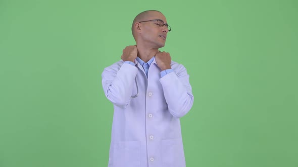 Stressed Bald Multi Ethnic Man Doctor Having Neck Pain