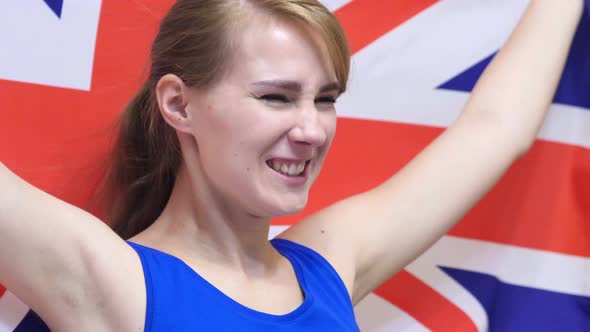 British Young Woman Celebrates Holding the British Flag
