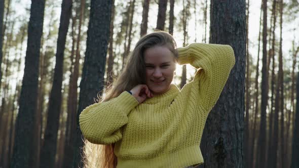 Beautiful Girl in the Forest with Long Hair Smiling