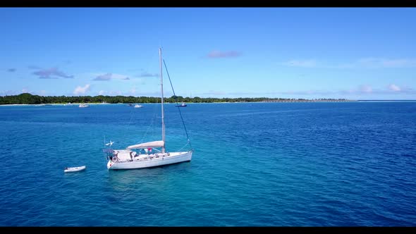 Aerial top down landscape of relaxing tourist beach adventure by turquoise lagoon with white sand ba