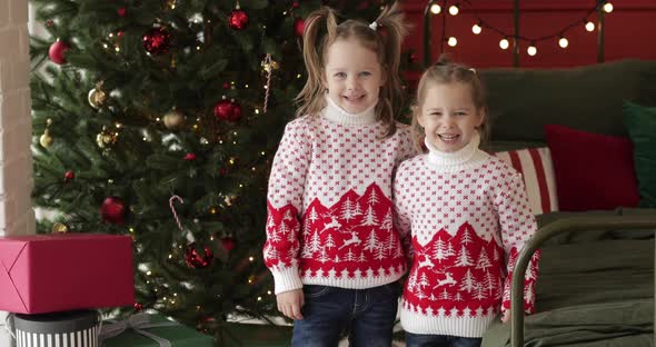 Smiling Small Sisters Waiting for the Celebration of the New Year