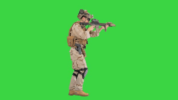 Soldier of Special Force Walking and Shooting on a Green Screen, Chroma Key.