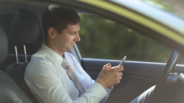 Entrepreneur Surfing Net on Phone in Car