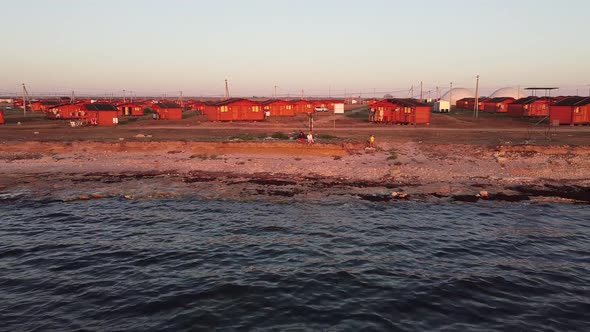 Aerial Photo with a View of the Beach and Camping From Small Houses at a Summer Evening Sunset in