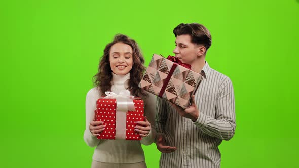 A Man and a Woman are Holding Gifts