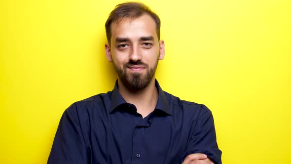 Young Man Enters the Frame Looks at the Camera and Smiles