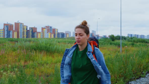 Young Woman Hiker Tourist Walks in Strange City