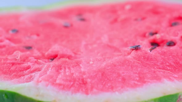 The cut watermelon rotates around the axis