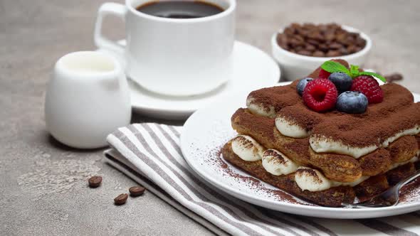 Portion of Tiramisu Dessert with Berries, Cup of Coffee and Cream on Concrete Background