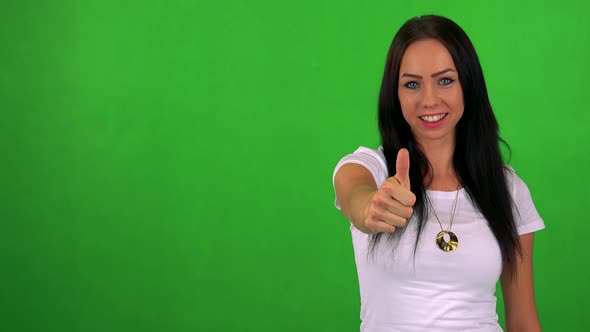 Young Pretty Woman Shows Thumb Up on Agreement - Green Screen - Studio