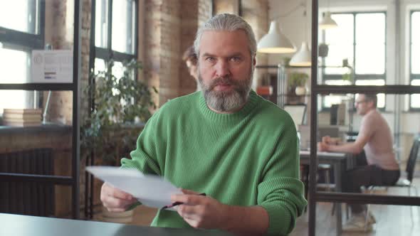 Mature Man Discussing Business Plan on Online Video Call