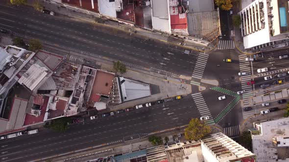 Aerial top down of vehicles diverting towards different lanes from intersection at Cordoba Avenue fo