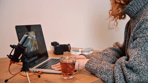 Young girl making tea and coming to table