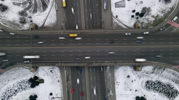 Aerial timelapse of the cars passing by on a highway and a bridge at winter