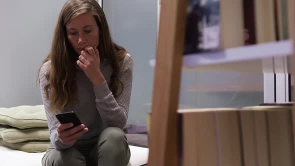 Creative businesswoman using smartphone in modern office