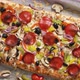 A Piece of Square Pizza with Basil Pepperoni Tomatoes and Mushrooms on a Iron Tray - VideoHive Item for Sale