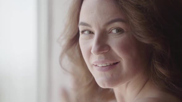 Close-up Portrait of a Pretty Mature Woman Looking at Camera