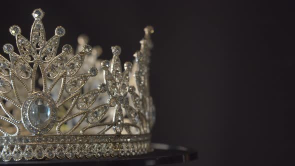 Beauty pageant, bride's or queen's crown on a turning display as in a museum, illuminated with black