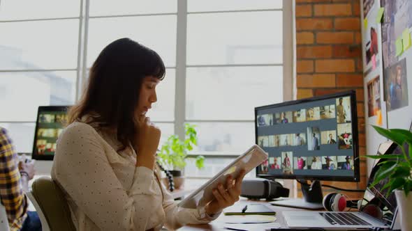 Female graphic designer using digital tablet in a modern office 4k