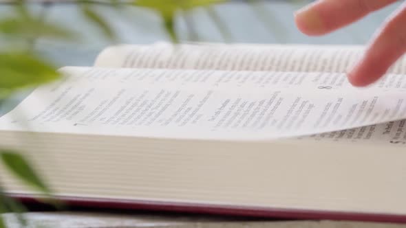 Close Up of Female Hands Turning Pages of a Book