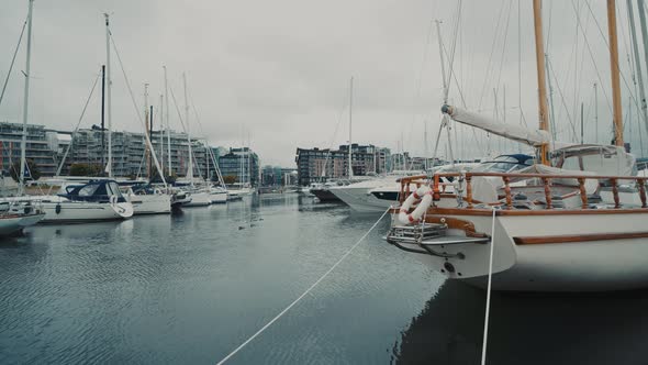 Blue Sailboat Moored to a Pier in Yacht Marina at Sunset