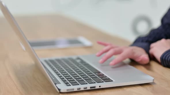 Female Hand Scrolling Touchpad of Laptop