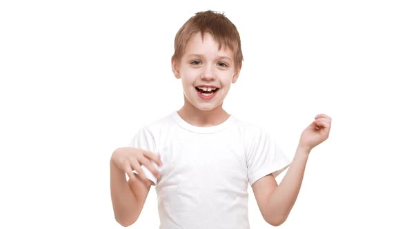 Cute Elementaryschool Aged Caucasian Boy Smiling on White Background and Waving Hands Then Fading