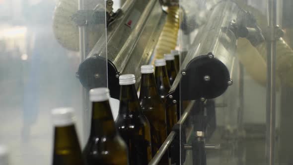 Glass bottles with water leave the blowing unit