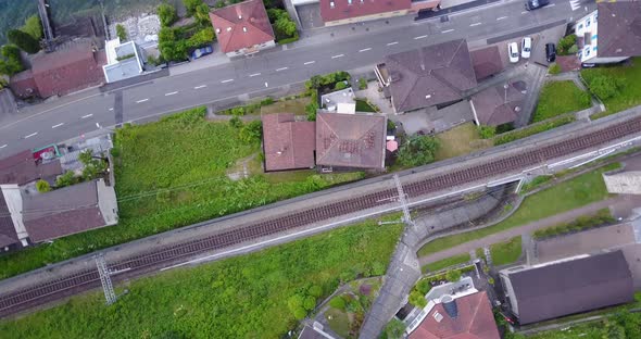 Aerial drone view of a town with train tracks near Lake Maggiore, Switzerland.