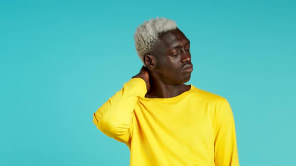 Young African American Man Having Pain in the Neck, Studio Portrait. Guy Putting Hands on Throat