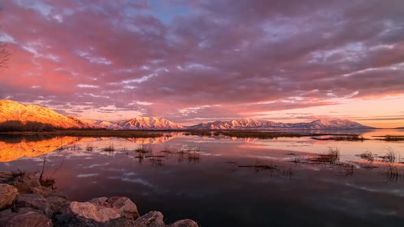 Timelapse reflecting in Utah Lake looking towards the snow capped mountains