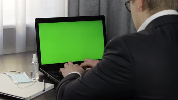 Man Have Video Call Conference on Laptop with Green Screen. Distance Work Online