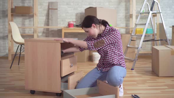 Young Woman Engaged in the Assembly of the Bedside Table