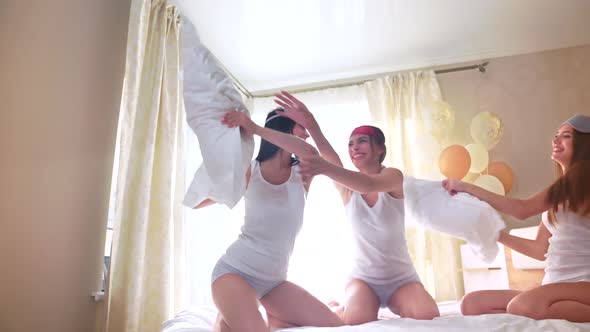 Girls Having Pillow Fight on Bed.