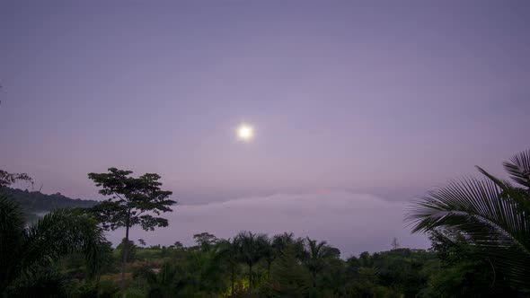 Timelapse Full moon reflecting bright light Above the sea of fog at dawn The time before sunrise