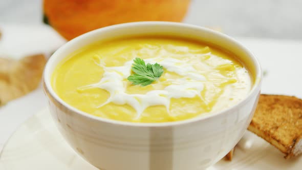 Pumpkin Soup in Bowl Served with Bread