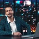 Man TV News and Show Sits at a Desk in a Studio with a Laptop - VideoHive Item for Sale