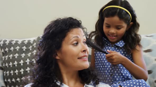 Little girl combing her mothers hair 4K 4k