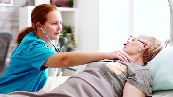 Old Lady Getting Her Heartbeats Checked By a Female Nurse