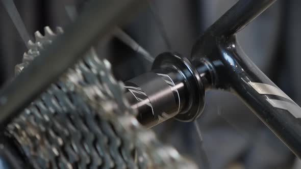 Bicycle wheel rotating. Bicycle gear and chain in motion, close up.