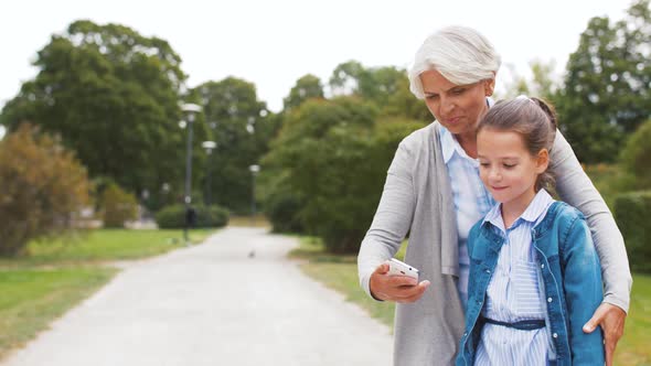 Grandmother and Granddaughter Take Selfie at Park 23