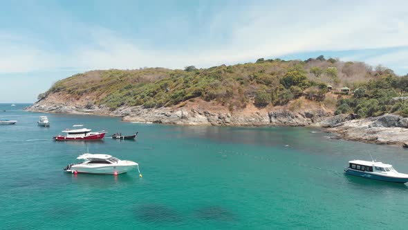 Moored fishing boats and tourism Yachts resting above the paradisiac shallow water in Ko Racha Yai