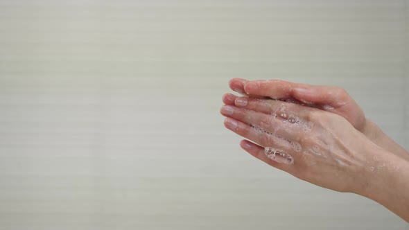 A Woman Washes Her Hands with White Soap Bubbles in Close-up. Demonstration of Hand Washing To