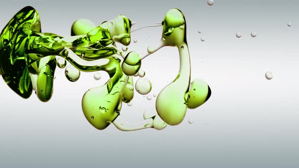 translucent abstract green oil bubbles and fluid shapes isolated in purified water. Side angle with