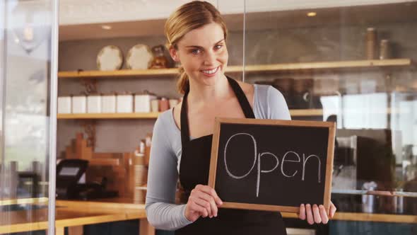 Smiling waitress with chalkboard