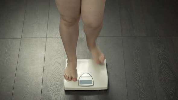 Legs of Woman Stepping on Home Scales, Normal Weight, Successful Diet Result