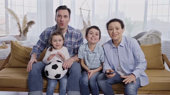 Family of Football Fans Watching Match on TV