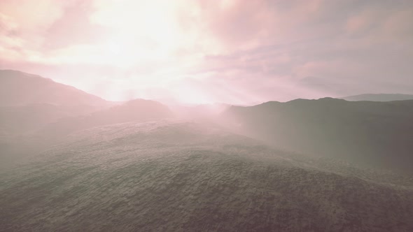 Black Volcanic Dust and Mountains with Fog in Background alt