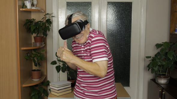 Senior Grandfather in Virtual Headset Glasses Watching Video in 3D Vr Helmet and Dancing, Having Fun