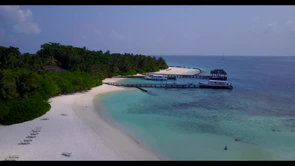 Aerial drone shot nature of idyllic coastline beach voyage by blue lagoon and bright sandy backgroun